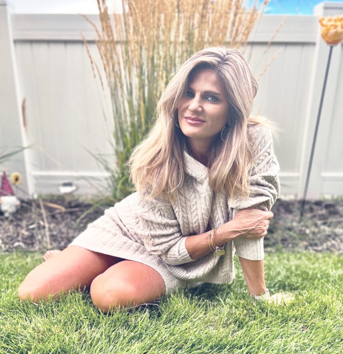 Athena Metos sitting on the grass in her garden